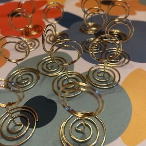 13 goldtone place card holders. I use them on my charcuterie to identify items.